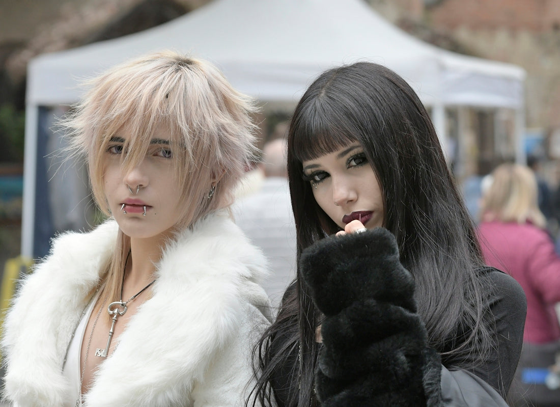 Two young women with distinctive hairstyles and alternative styles.