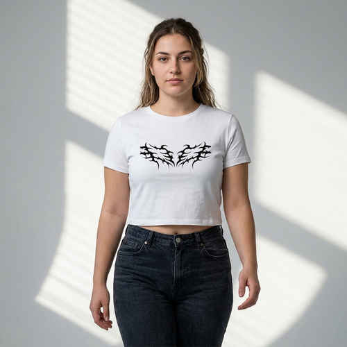 White cropped t-shirt with black tribal wing graphic, paired with dark jeans, modern casual style
