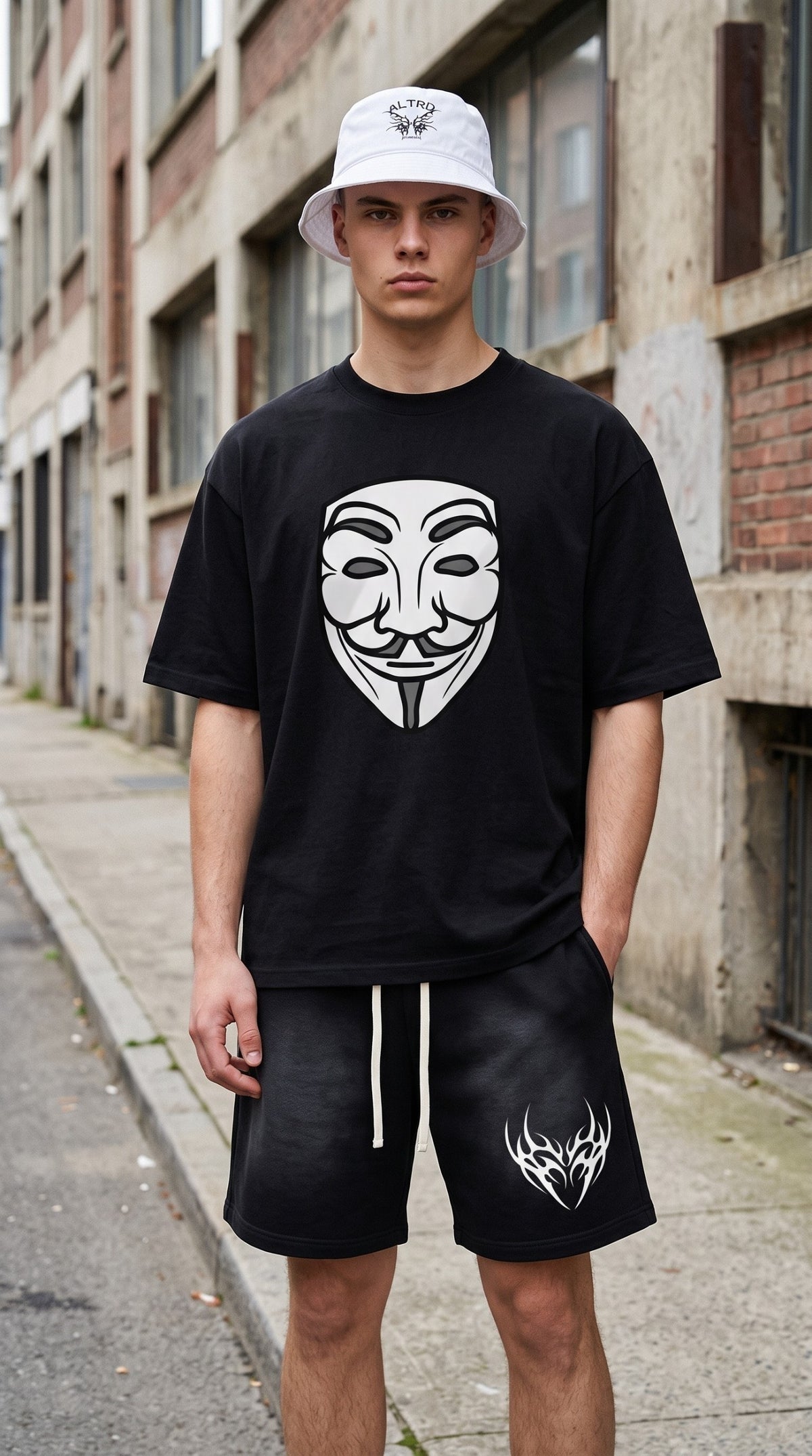 Model wearing ALTRD Apparel black heavyweight boxy t-shirt with anonymous mask graphic and white bucket hat