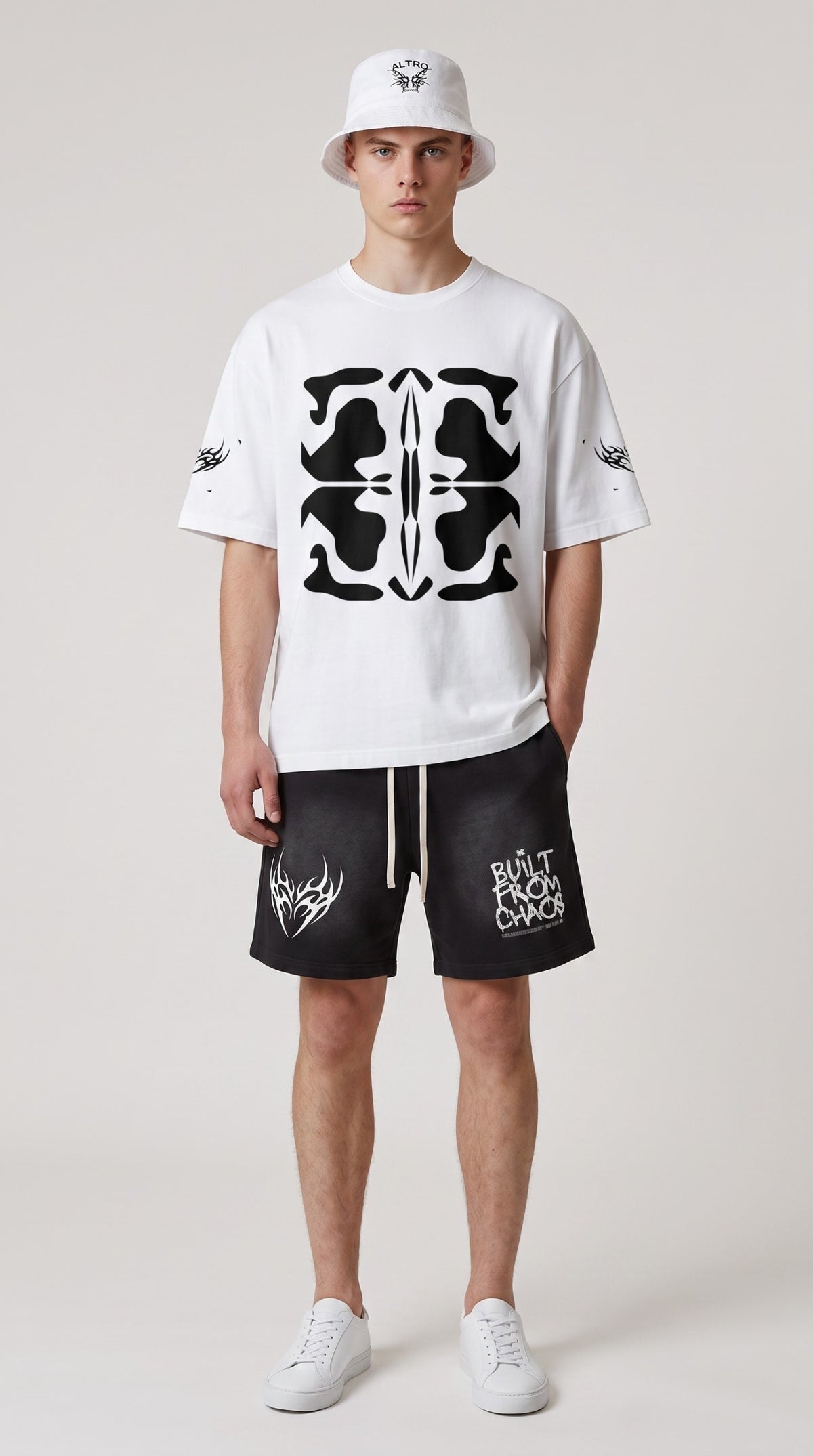 Model wearing ALTRD Apparel black cotton shorts with raw hem, sunfade wash, and graphic prints, paired with white tee.