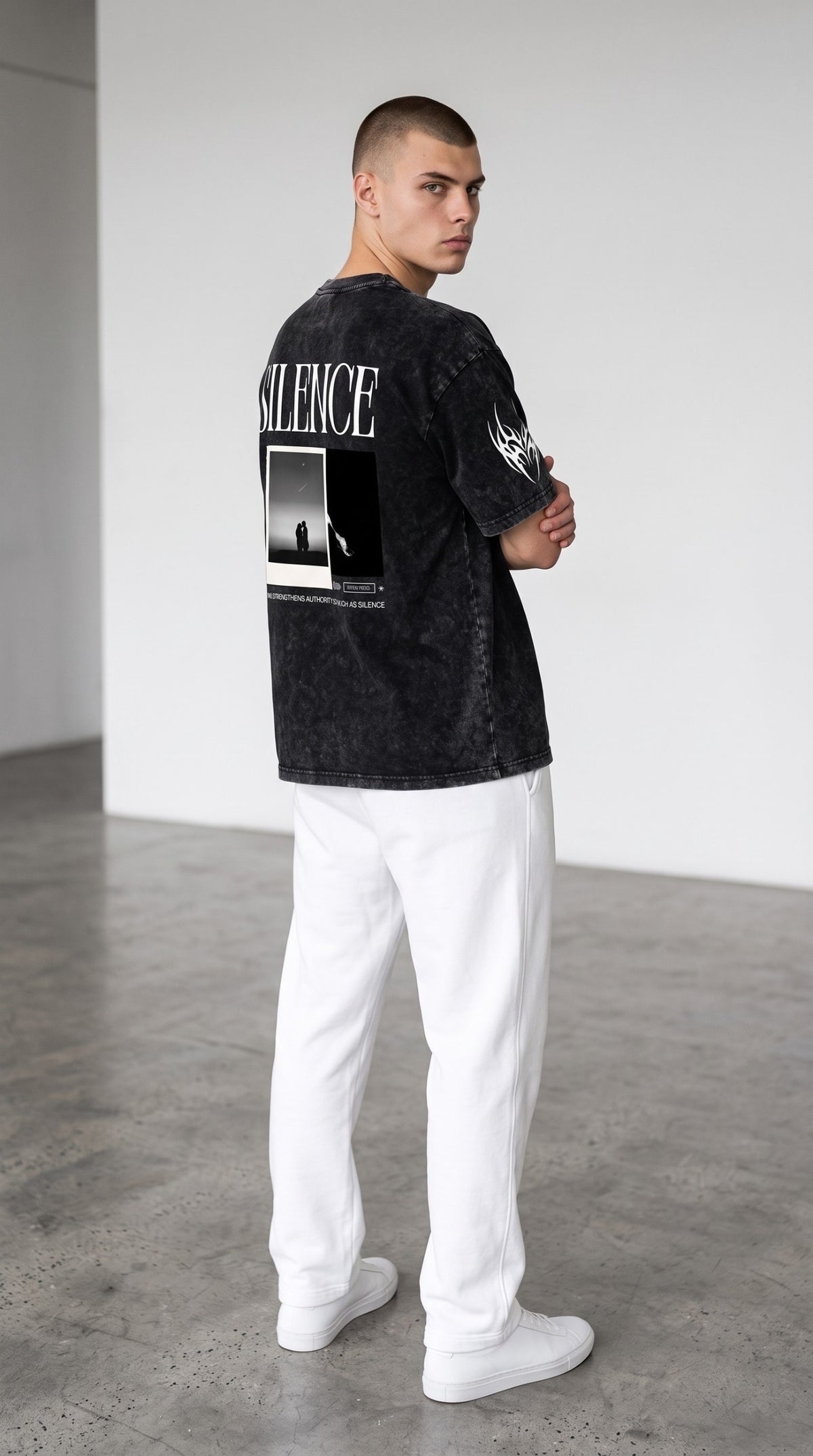 Model wearing ALTRD Apparel black snow-washed oversized cotton t-shirt with Silence graphic print on back