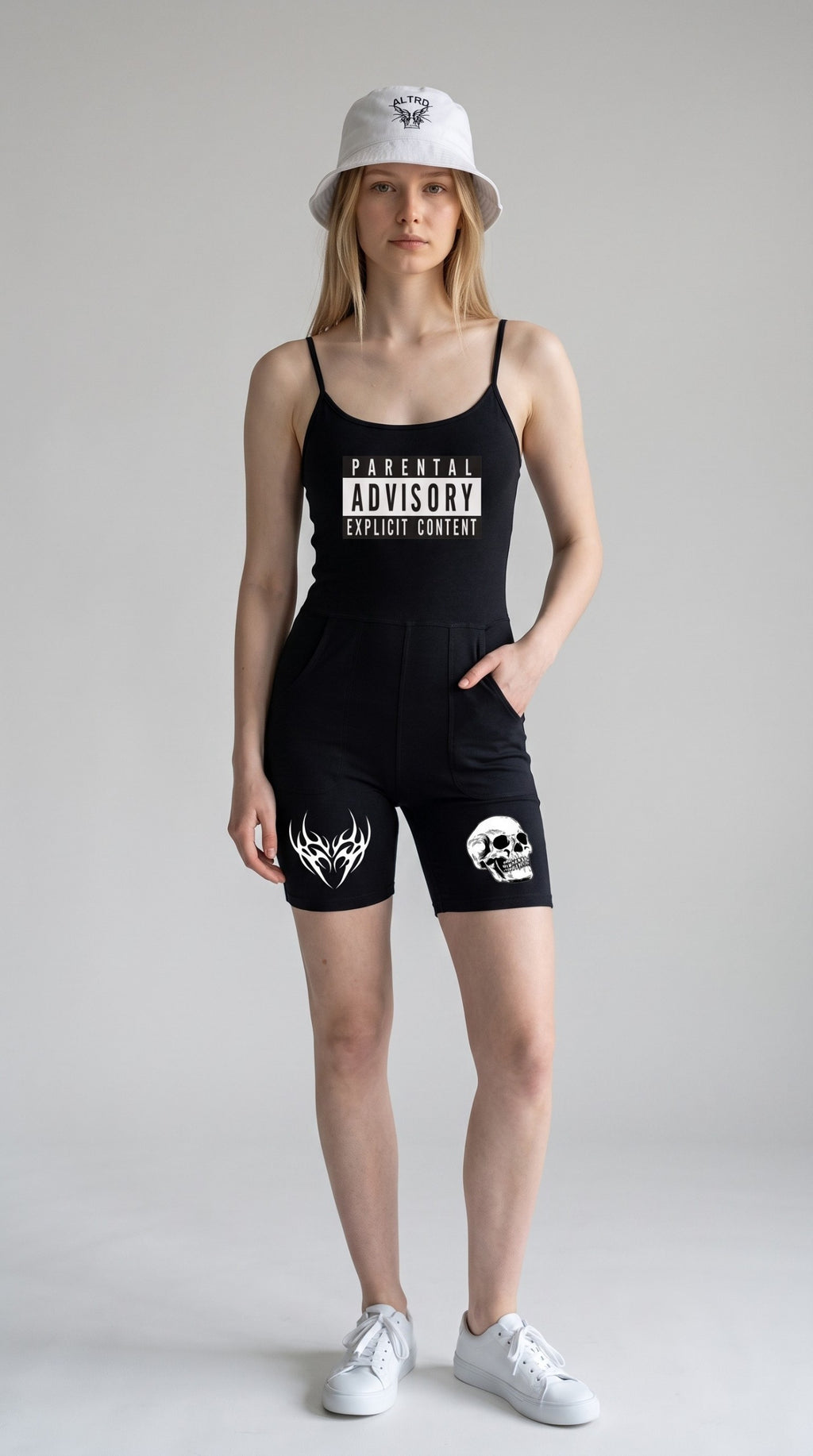 ALTRD Apparel black bodycon yoga romper with U-neck, Parental Advisory graphic, and skull print worn with bucket hat
