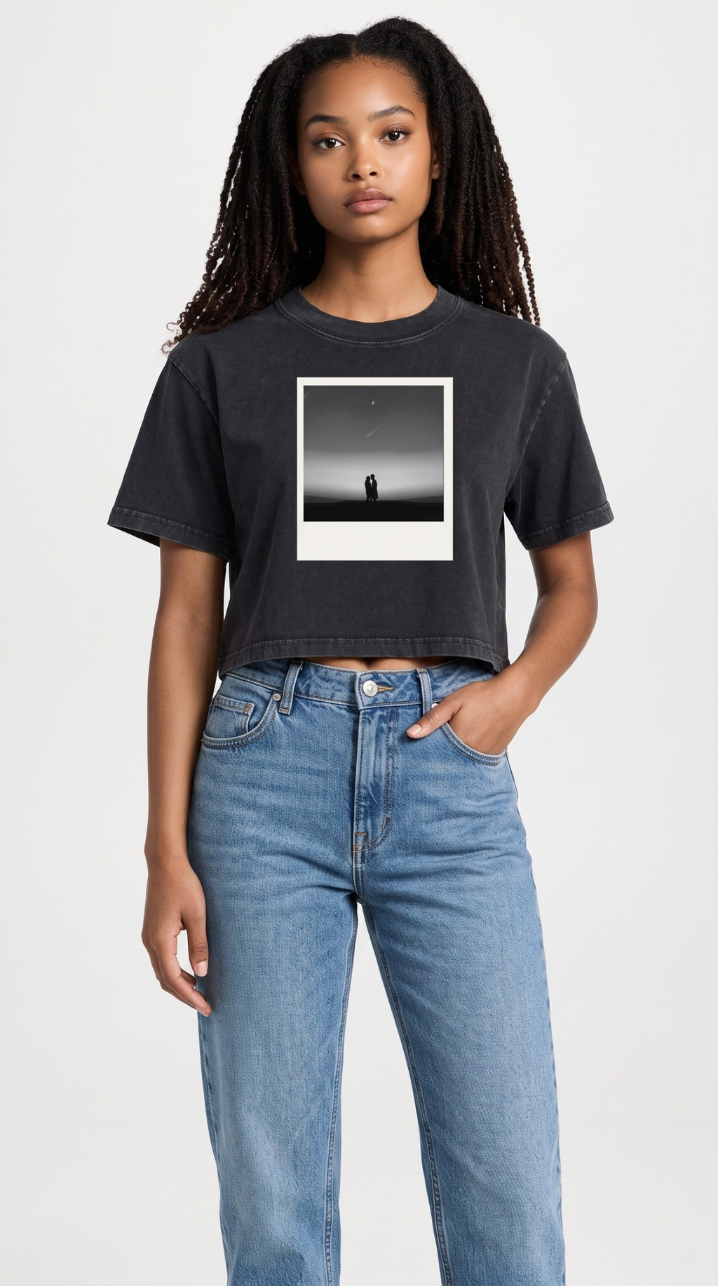 ALTRD Apparel women's black mineral wash cotton crop t-shirt with a graphic print, worn with blue denim jeans.