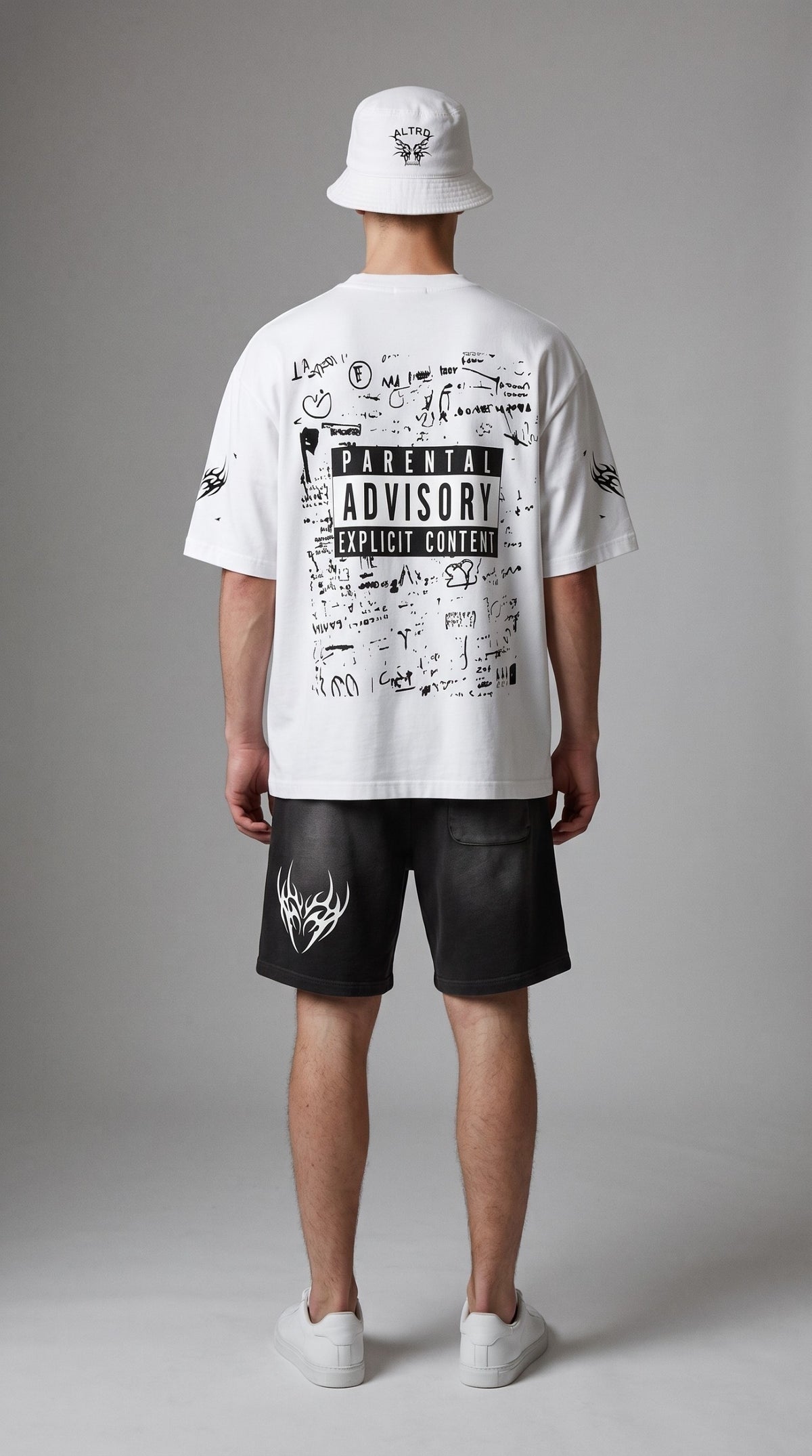 Model wearing ALTRD Apparel white oversized boxy t-shirt with Parental Advisory graphic and matching bucket hat
