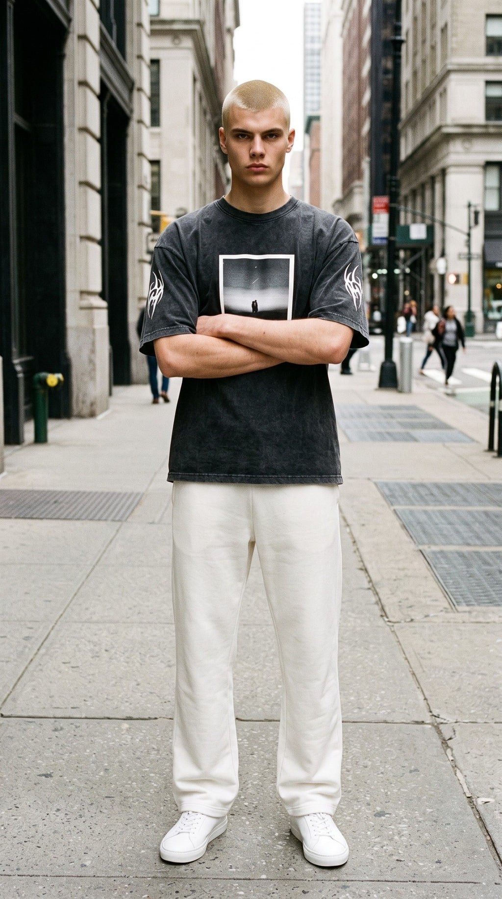 ALTRD Apparel oversized snow-washed black cotton t-shirt with graphic print and sleeve embroidery on a male model