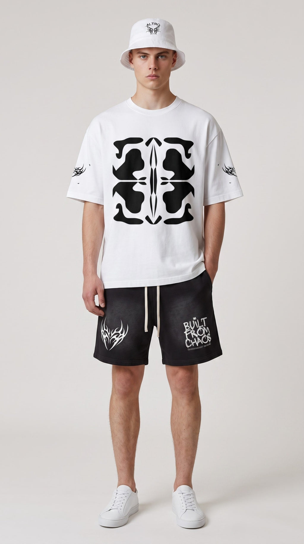 ALTRD Apparel white boxy oversized t-shirt with black graphic print worn by a model with a matching bucket hat