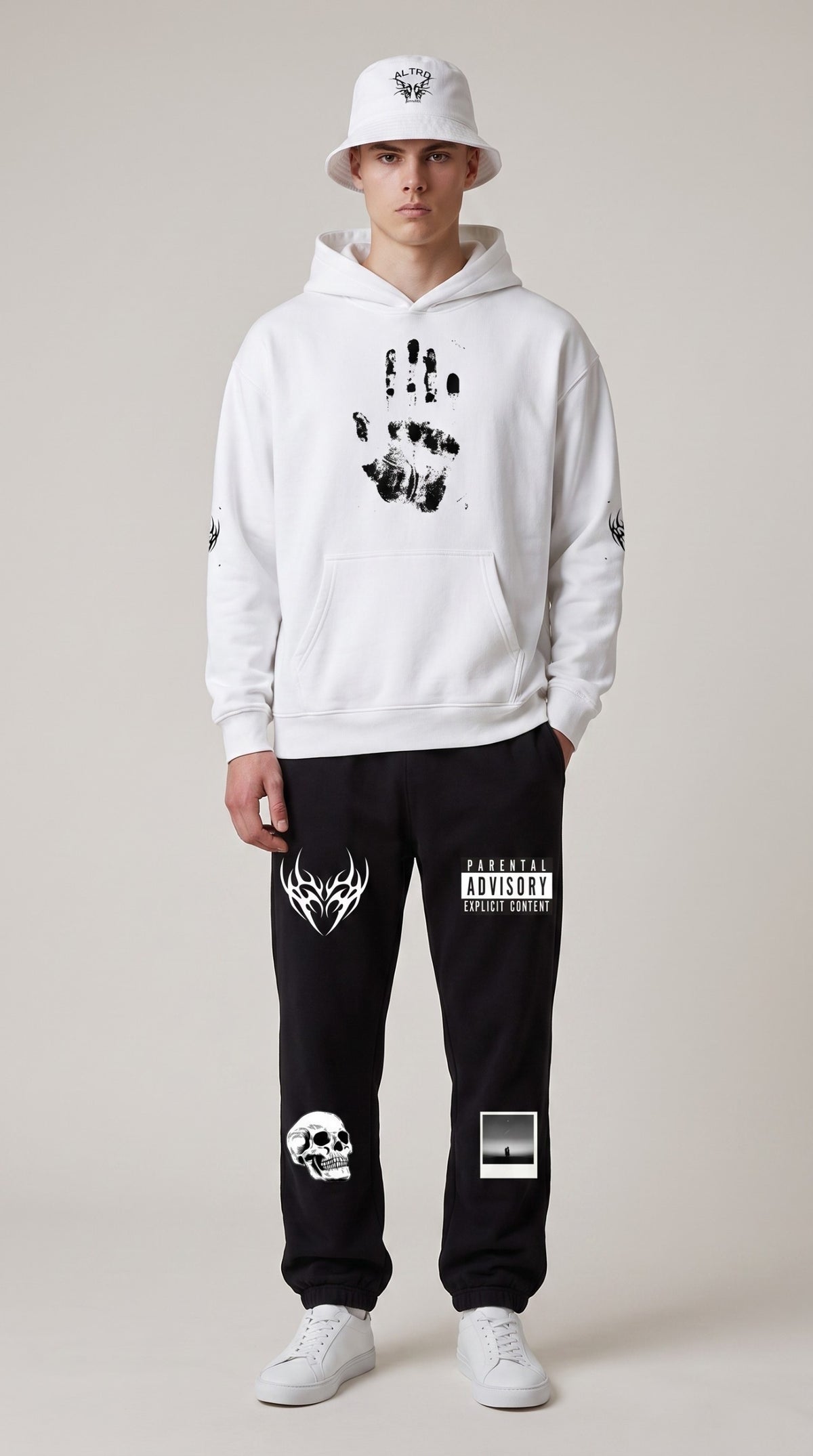ALTRD Apparel model wearing a white heavyweight hoodie with handprint graphic, black joggers, and a white bucket hat.