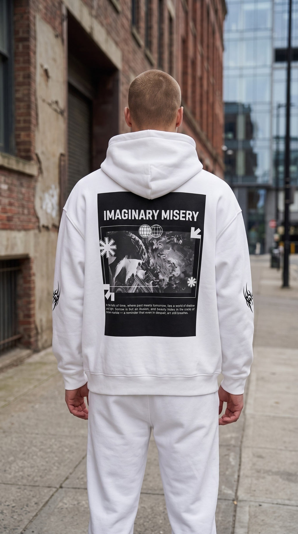 ALTRD Apparel white oversized fleece hoodie with a large black graphic print on the back, worn by a man outdoors.